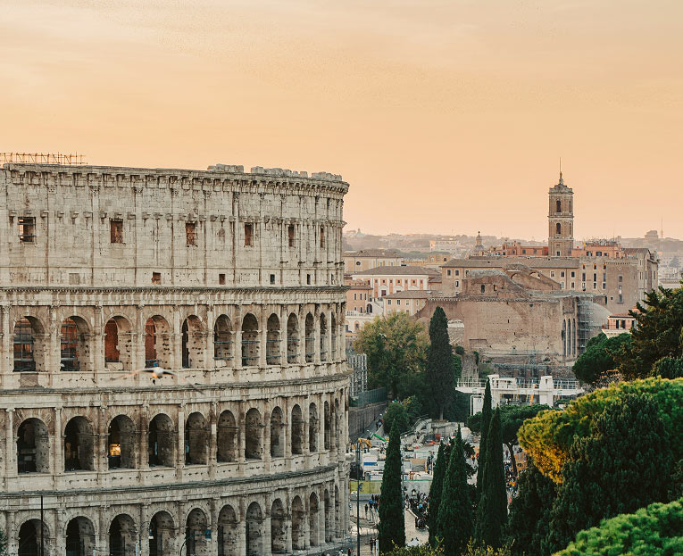 Colosseum and Roman skyline at sunset in Rome