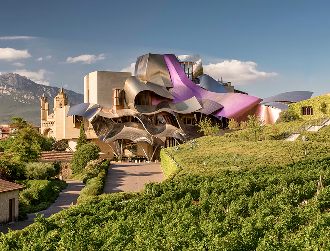 The Guggenheim Museum Bilbao with its distinctive titanium architecture under a blue sky