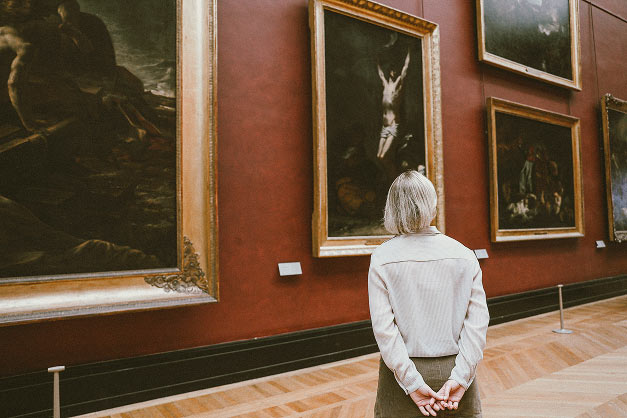 Visitor viewing artwork in a museum gallery
